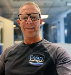 HVAC engineer in glasses wearing Essex Cooling Ltd uniform
