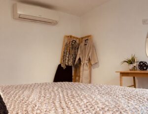 the new A/C unit mounted high on the ceiling to blend into the room decor