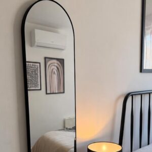 the a/c unit reflecting in the mirror of the spare room